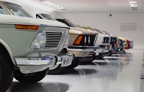 A row of classic cars in a showroom