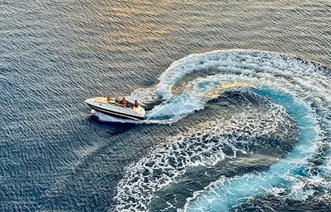 A recreational boat making a turn on the water