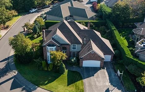 A large brick home viewed from above