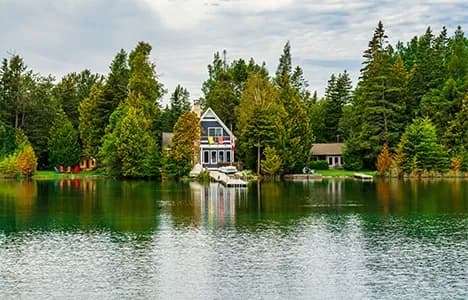 A waterfront home surrounded by trees